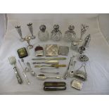 A box containing various silver cutlery, spill vases, silver mounted dressing table bottles,