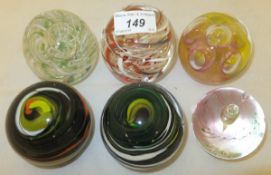 Three Langham glass paperweights and three Wedgwood glass paperweights