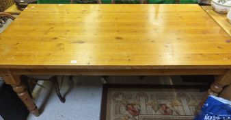 A modern pine kitchen table on turned and ringed legs