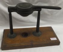 A Victorian lemon squeezer by W Thornhill & Co on an oak base (Rg. No.