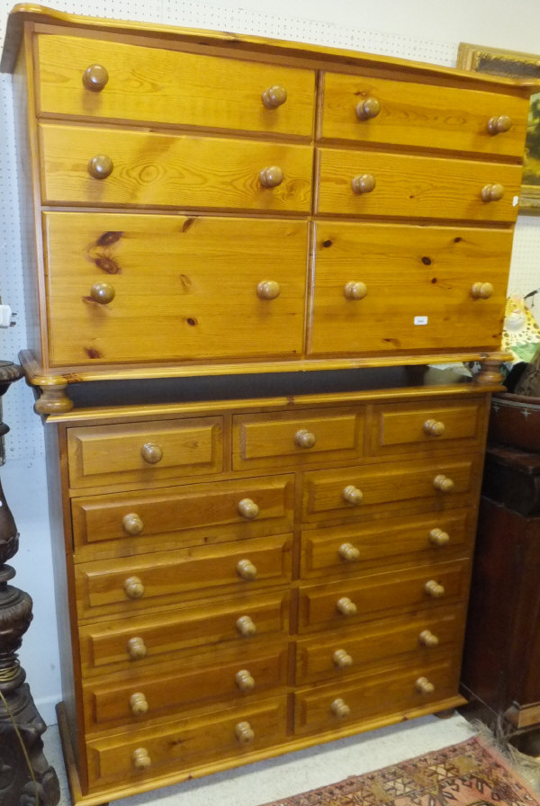 A modern pine chest of 13 assorted drawers with turned knob handles, and a further pine chest (2)