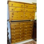 A modern pine chest of 13 assorted drawers with turned knob handles, and a further pine chest (2)