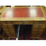 A circa 1900 mahogany pedestal desk, the tooled and gilded red leather insert above a central drawer