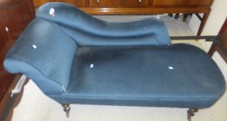 A Victorian chaise longue raised on mahogany turned and ringed legs to brass caps and castors,