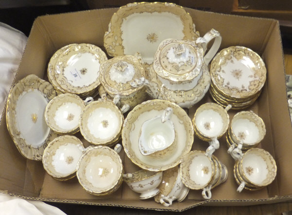 A 19th Century Rockingham style Staffordshire gilt decorated tea service to include teapot, sucrier,