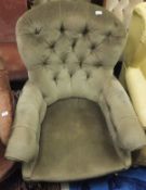 A Victorian mahogany button back armchair on turned front legs