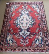 A Persian rug, the central medallion in cream,
