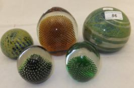 A large Mdina glass paperweight, a smaller version, and three Whitefriars paperweights with internal