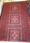 A Caucasian rug, the three central rectangular medallions in red, cream and black within red,