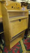 An oak student's bureau with open shelves above the fall front and open shelves below