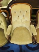 A Victorian mahogany framed armchair in pale yellow button back upholstery