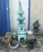 A Far Eastern green painted garden statue of a pagoda, another similar painted black,