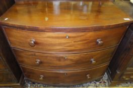 A 19th Century mahogany bow fronted chest of three long drawers on turned feet