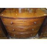 A 19th Century mahogany bow fronted chest of three long drawers on turned feet