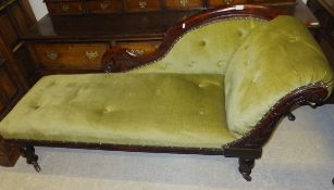A Victorian stained walnut framed scroll end chaise longue upholstered in green velour fabric,