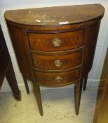 An early 20th Century demi lune side table with marquetry decoration, with three drawers,