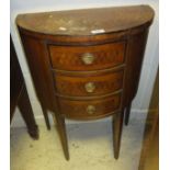 An early 20th Century demi lune side table with marquetry decoration, with three drawers,