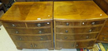 A pair of 20th Century walnut bow fronted bedside chests/cabinets