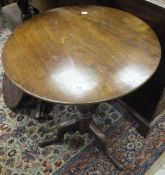 A 19th Century circular mahogany tripod table on ringed and turned central support to hipped tripod