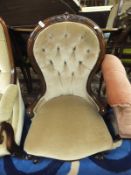 A Victorian mahogany framed salon chair in pale yellow button back upholstery,