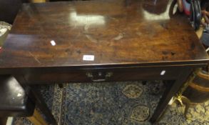 A circa 1800 mahogany fold-over tea table with single drawer on square tapered legs