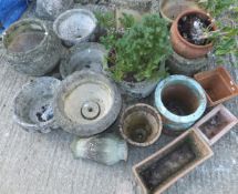 An assortment of composite stone and terracotta garden planters