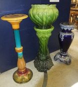 A Majolica torchere/plant stand decorated in shades of turquoise, mustard and green,