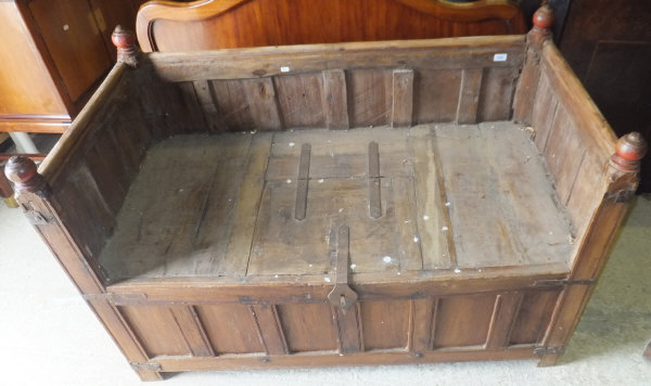 A 20th Century Indian teak box seat bench with panelled back and sides