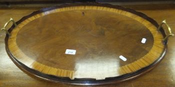 A circa 1900 mahogany and satinwood banded oval tray with brass handles