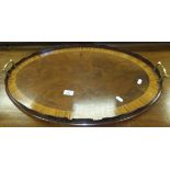 A circa 1900 mahogany and satinwood banded oval tray with brass handles