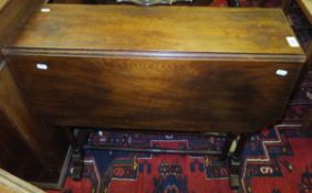 A 19th Century mahogany Sutherland table on ringed and turned supports united by stretchers