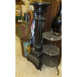 A circular lacquered pedestal on reeded column to square base, a cast iron three tiered stand,