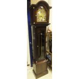 A modern mahogany cased long case clock, the brass arched dial with silver coloured chapter ring and