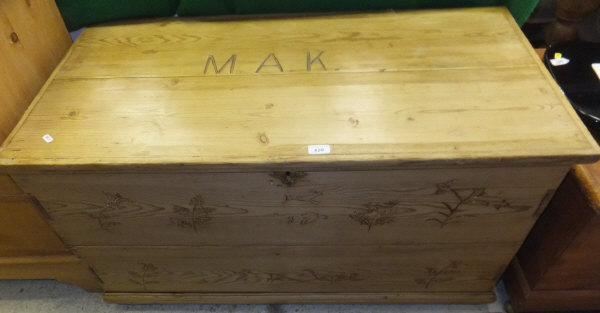 A pine blanket box / coffer with decorative carvings to front