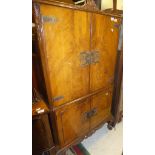 A 20th Century walnut drinks' cabinet in the 18th Century style with two cupboard doors enclosing a