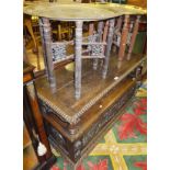 A Victorian carved oak monk's settle and two Benares brass topped folding coffee tables