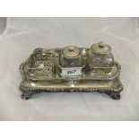 A George III silver inkstand with applied gadrooned edge, raised on four scroll feet (by Edward