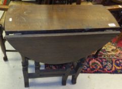 A 17th century style oak drop leaf gate leg tea table on splayed feet