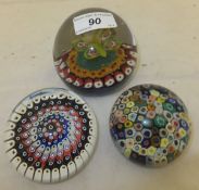 Three various millefiore paperweights comprising one set with internal butterfly, another with close