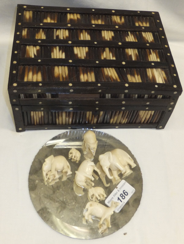 A porcupine quill box and a small selection of carved ivory animals