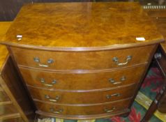 A 20th Century walnut bow fronted chest of four long drawers