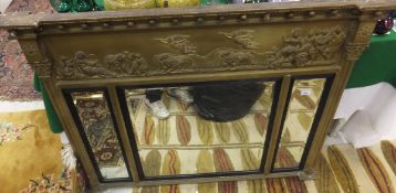 A 19th Century giltwood and gesso framed overmantel mirror in the Regency taste, the three