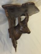 A Black Forest carved wooden wall bracket with chamois head decoration