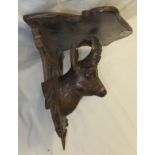 A Black Forest carved wooden wall bracket with chamois head decoration