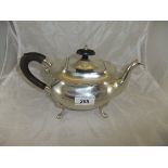 A George VI silver teapot of rounded rectangular form raised on four scroll feet,