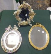 A Sitzendorf type floral encrusted and cherub decorated porcelain easel backed mirror, a