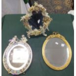 A Sitzendorf type floral encrusted and cherub decorated porcelain easel backed mirror, a