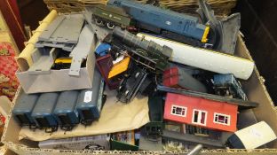 A box containing various '00' gauge toy trains including various locomotives, rolling stock,