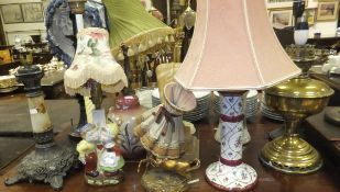 A large collection of various table lamp bases,