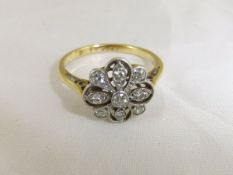 An 18 carat gold and diamond set dress ring in the form of a flower CONDITION REPORTS Overall with